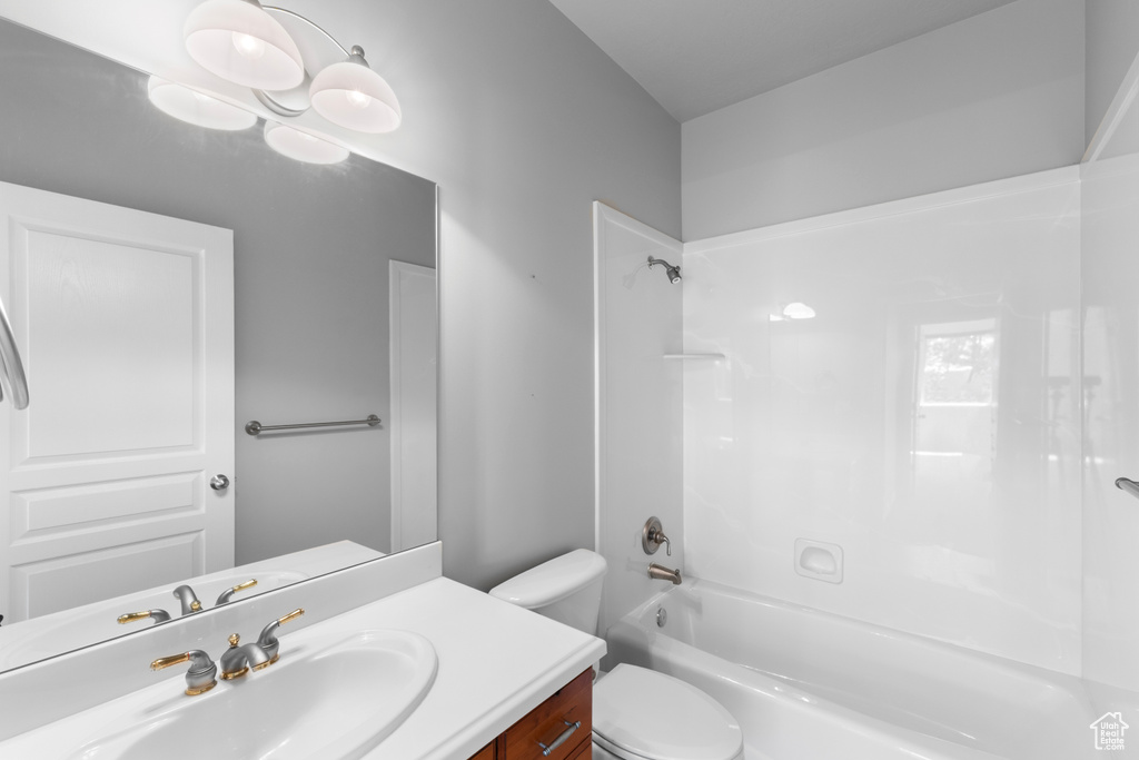 Bathroom featuring toilet, washtub / shower combination, and vanity
