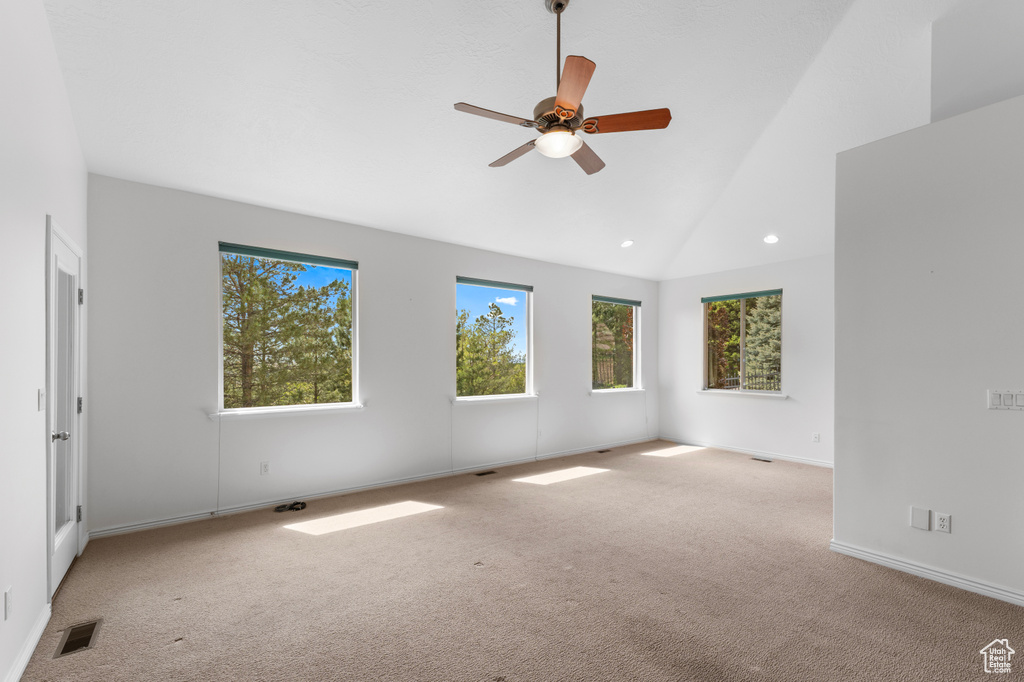 Carpeted spare room featuring ceiling fan, lofted ceiling, recessed lighting, and baseboards