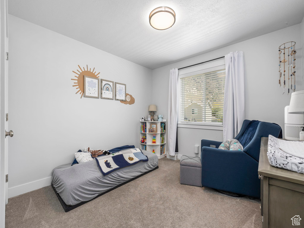 Carpeted bedroom with baseboards