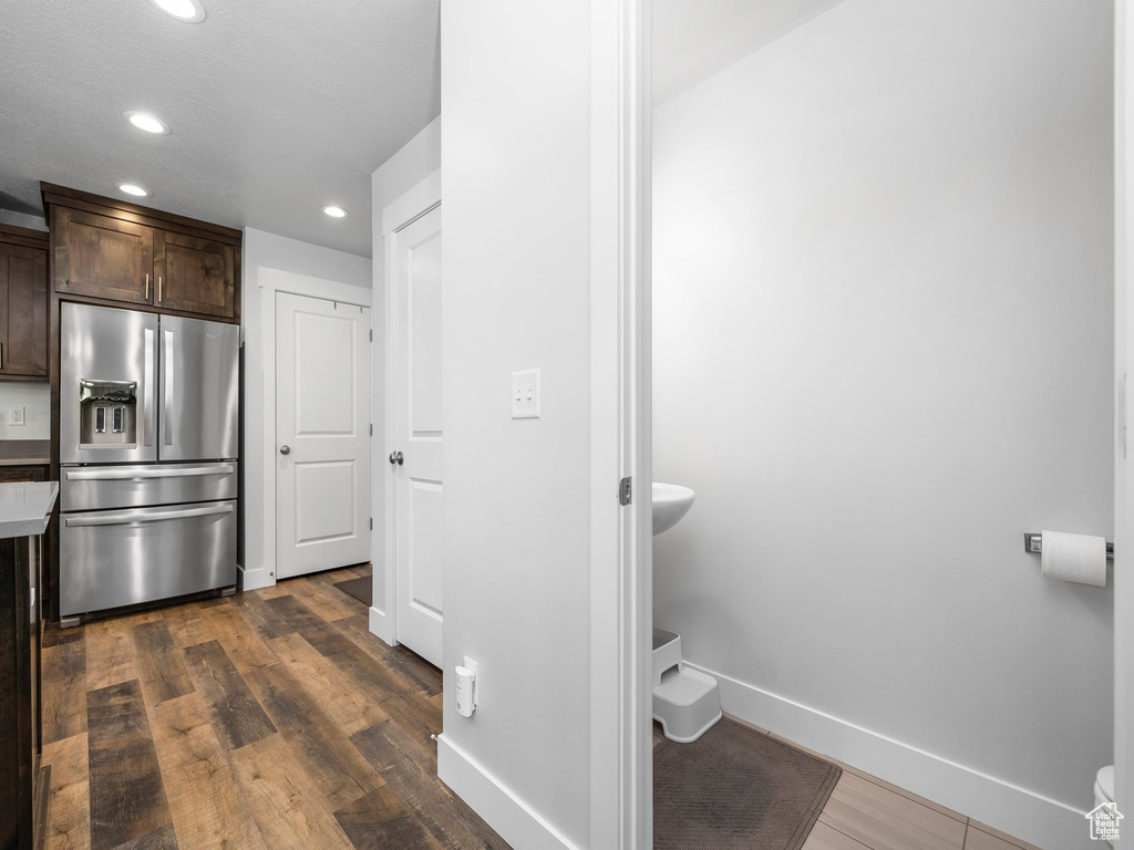 Bathroom featuring recessed lighting, baseboards, wood finished floors, and toilet