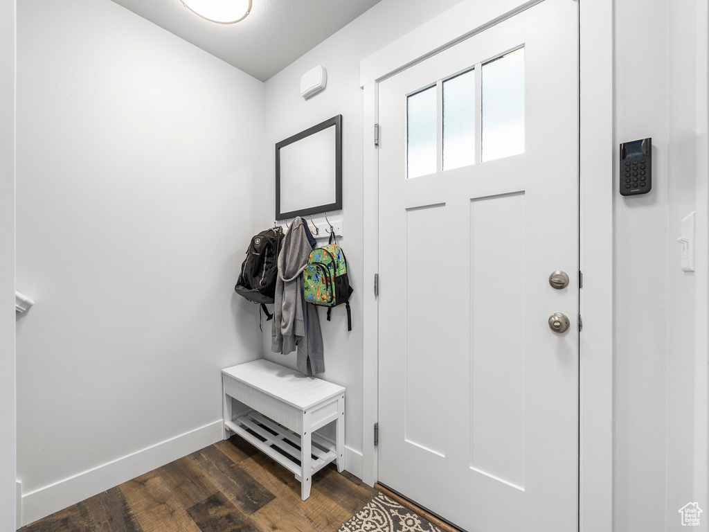 Mudroom featuring baseboards and dark wood-style floors