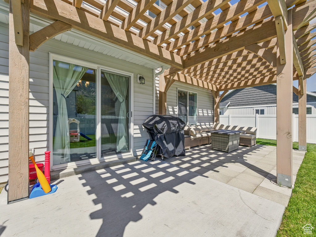 View of patio / terrace with an outdoor hangout area, a pergola, and fence
