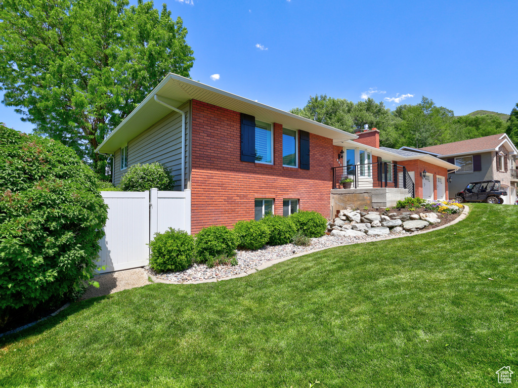 View of home\'s exterior featuring a garage and brick siding