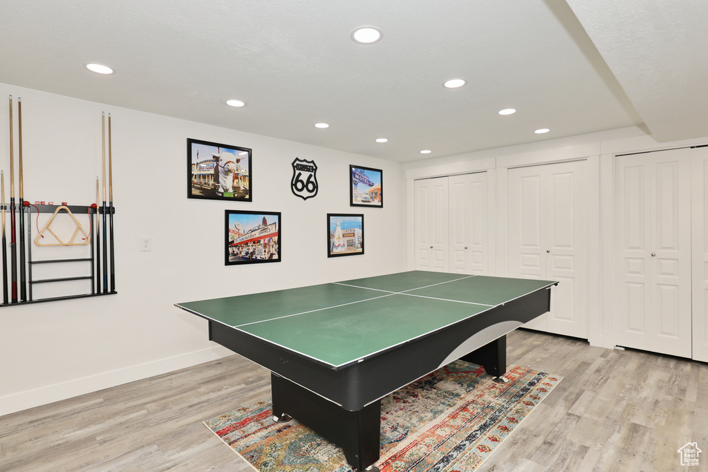 Recreation room with light wood-style flooring, recessed lighting, and baseboards