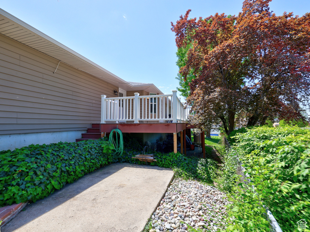View of yard with a deck, stairway, and a patio area