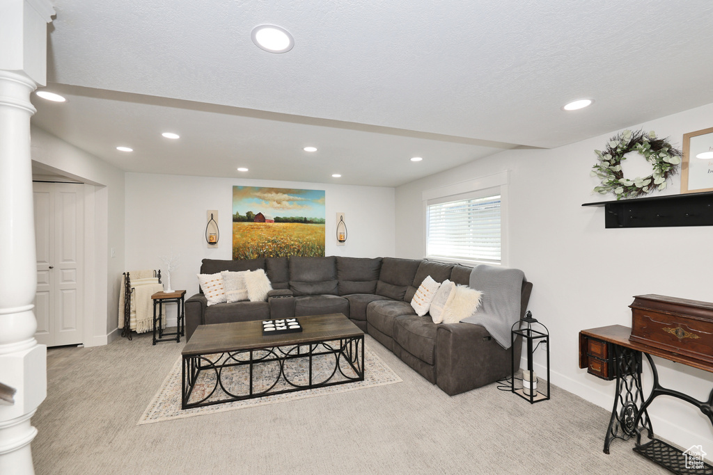 Living room featuring carpet, recessed lighting, baseboards, and ornate columns