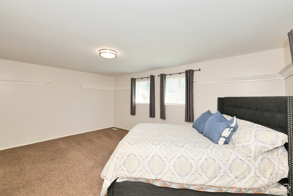 Bedroom with carpet floors and baseboards