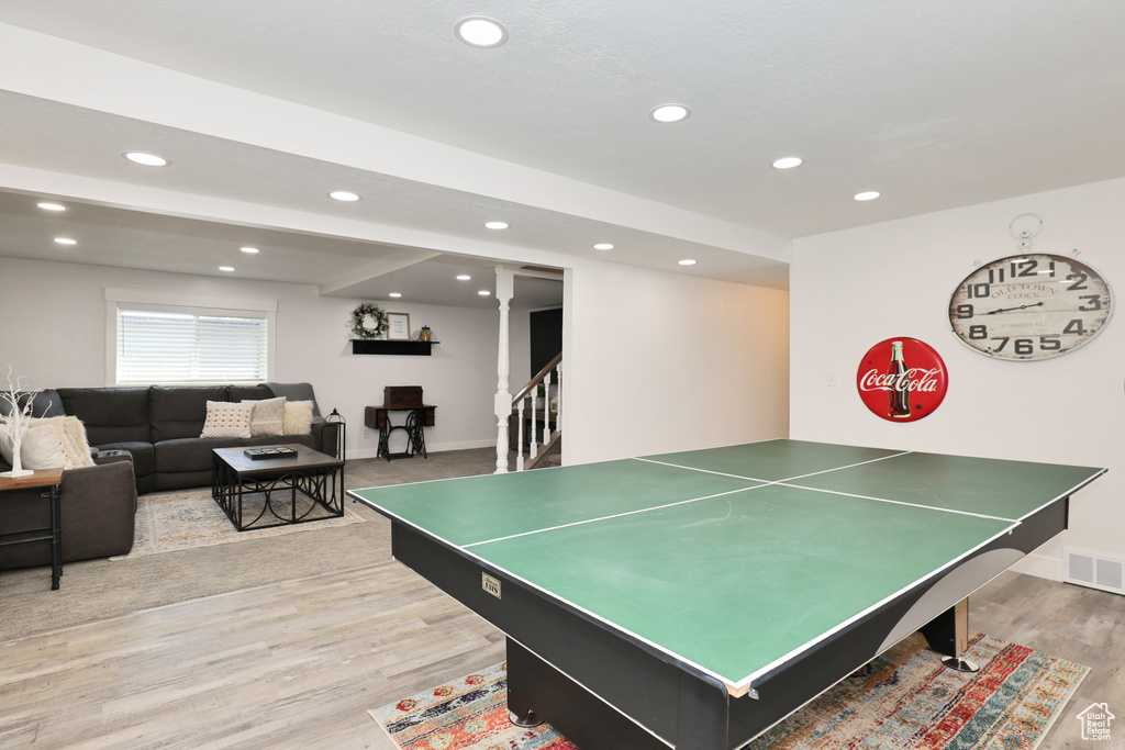 Recreation room with recessed lighting, light wood-style floors, and baseboards