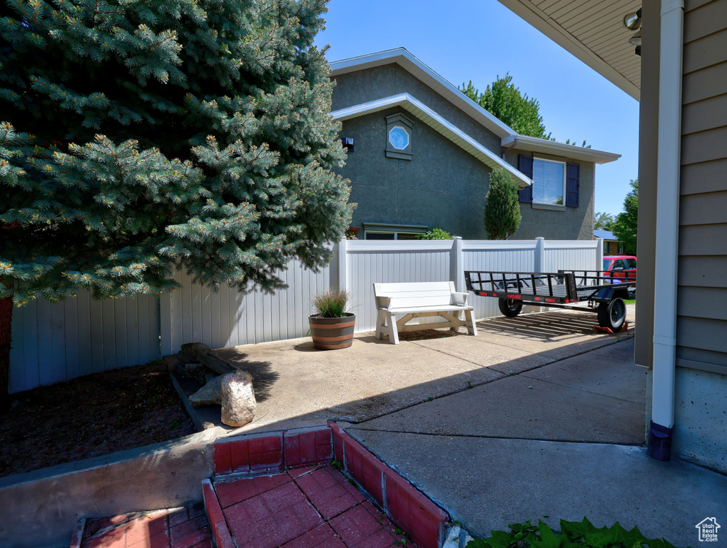 View of patio featuring fence