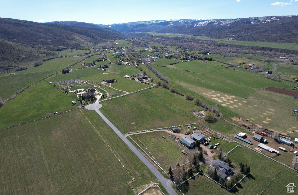 Aerial overview of property\'s location with rural landscape and a mountainous background