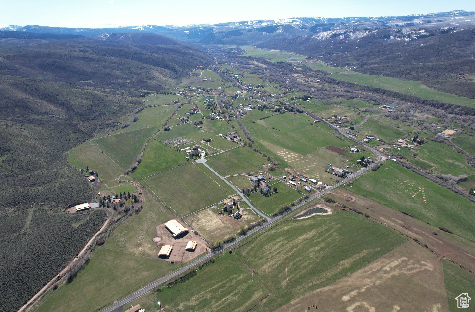 Aerial overview of property\'s location with mountains and rural landscape