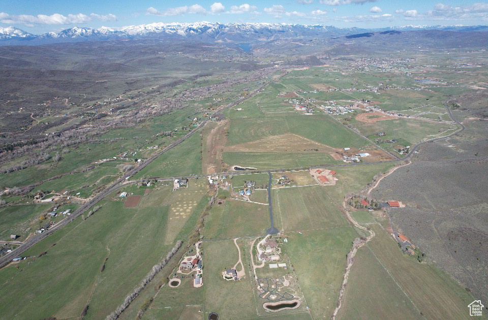 Aerial overview of property\'s location with rural landscape and mountains