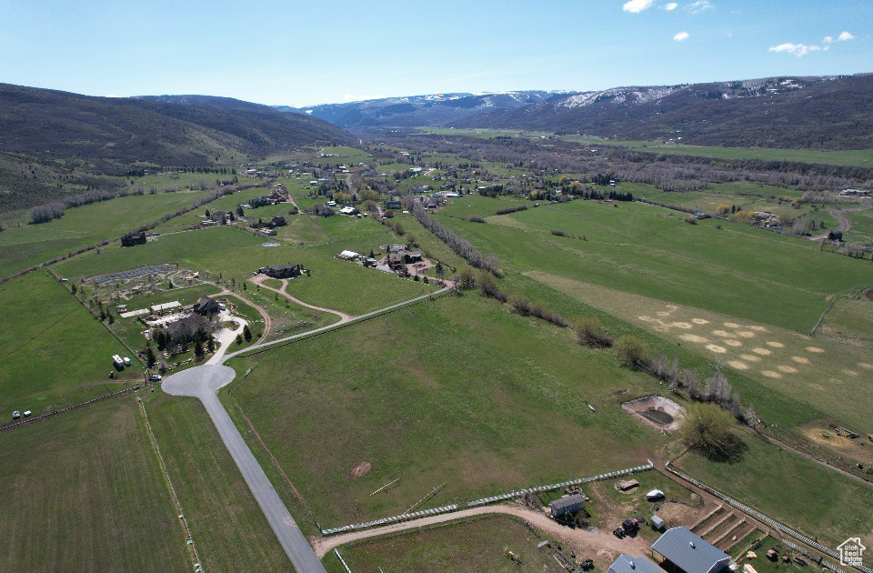 Aerial overview of property\'s location with rural landscape and mountains