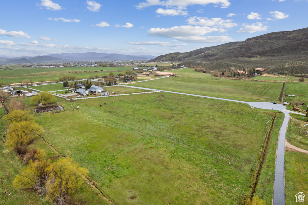 Aerial overview of property\\\'s location featuring rural landscape, a mountain backdrop, and agricultural land
