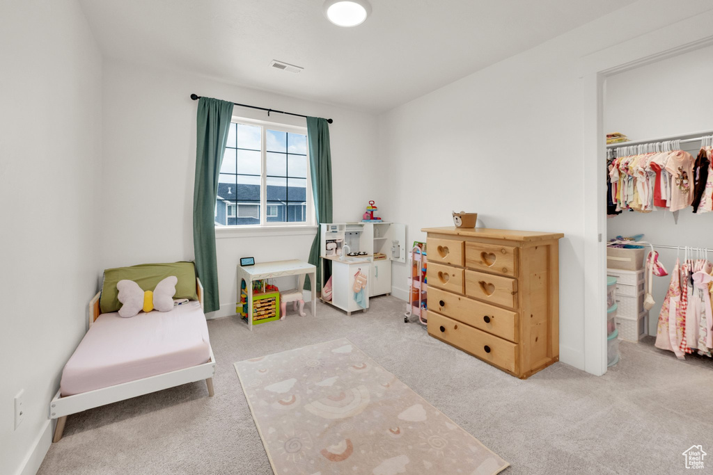 Bedroom with carpet, a closet, and baseboards