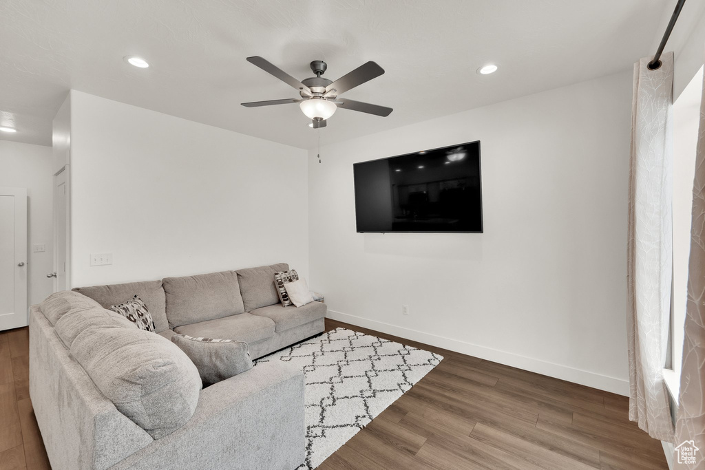 Living area featuring wood finished floors, recessed lighting, ceiling fan, and baseboards