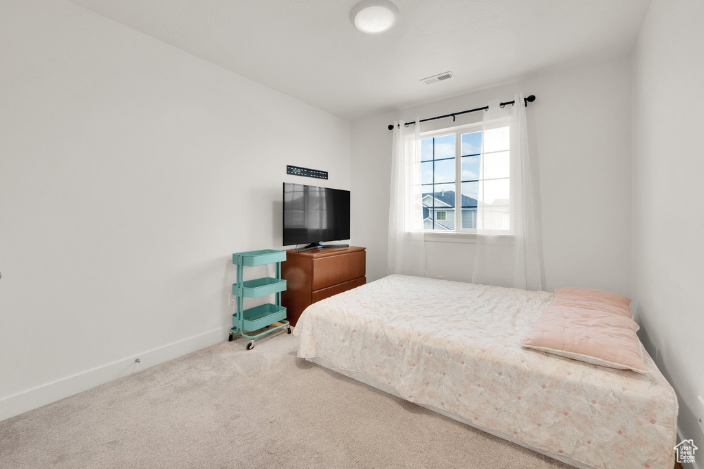 Carpeted bedroom with baseboards