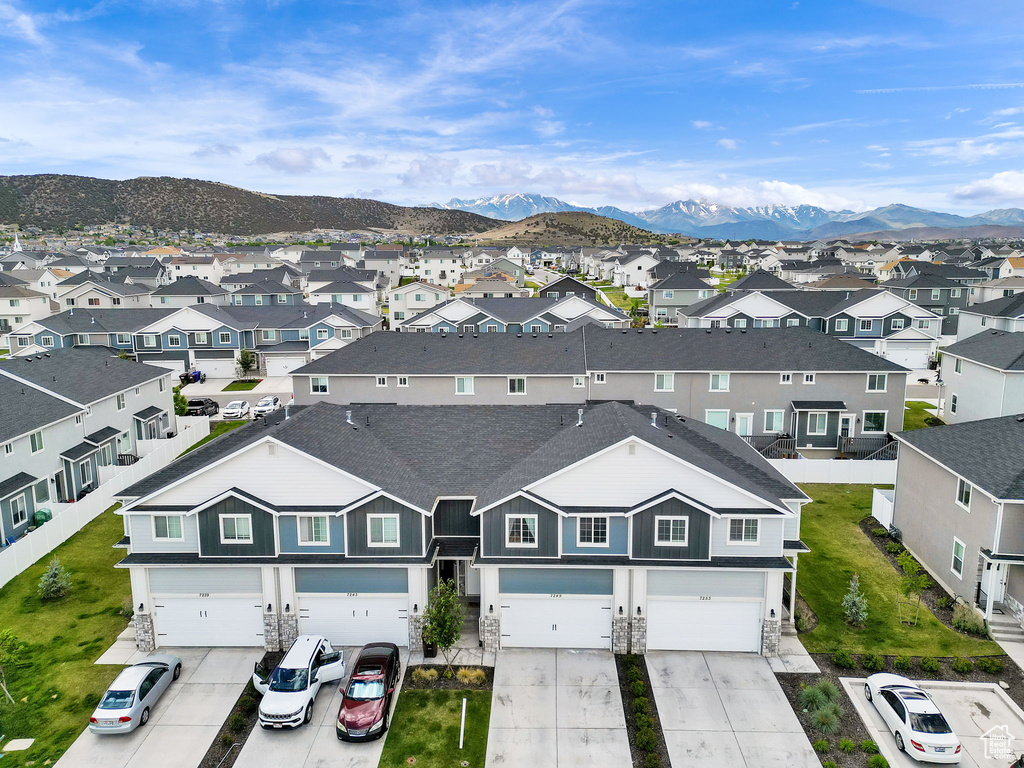 Aerial view of residential area featuring a mountainous background