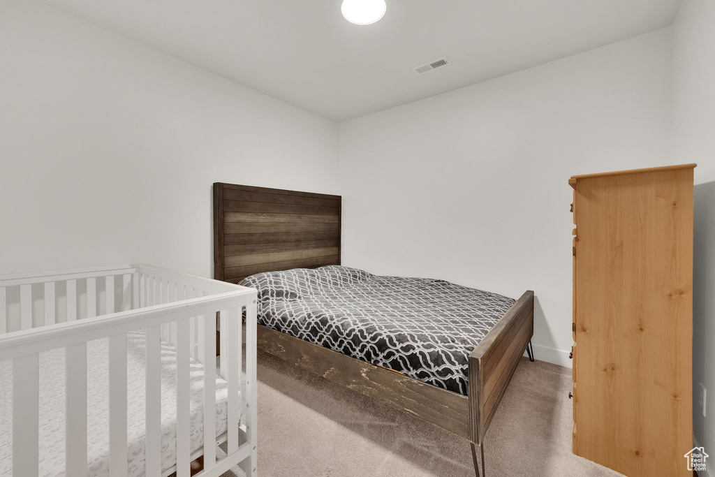 Bedroom with carpet flooring and baseboards