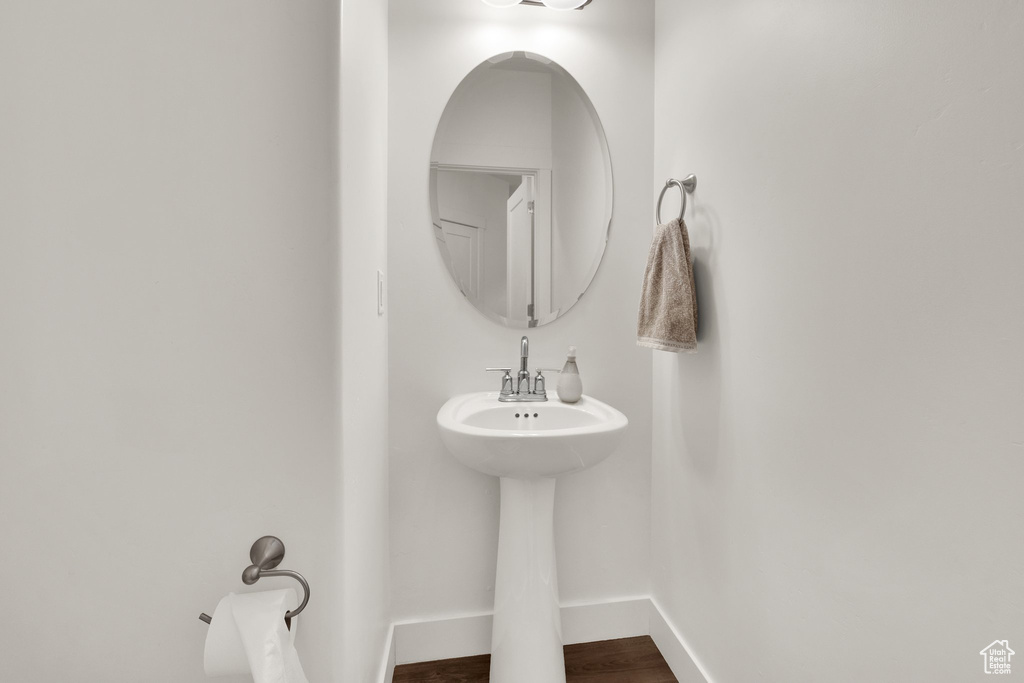 Bathroom featuring baseboards and wood finished floors