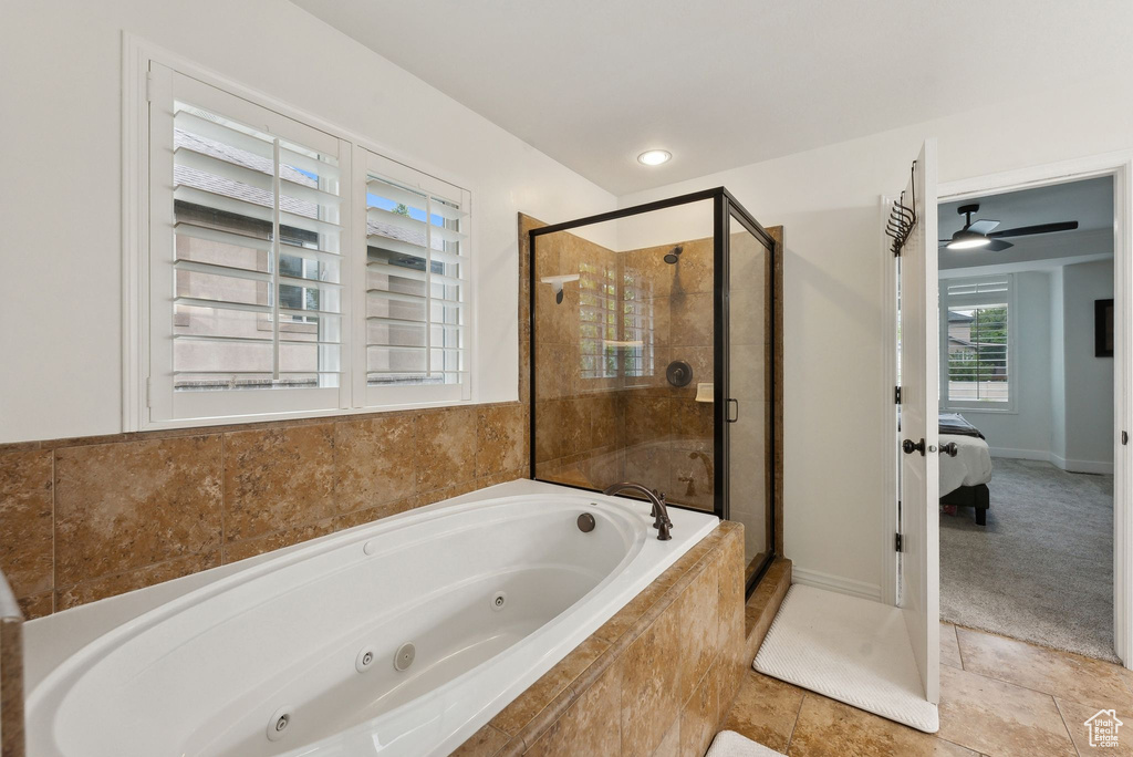 Full bathroom featuring a shower stall, a tub with jets, and ensuite bathroom