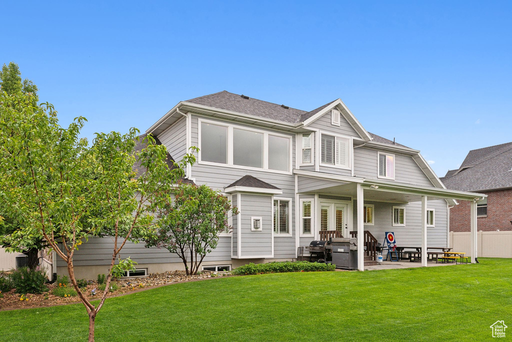 Rear view of house featuring a patio