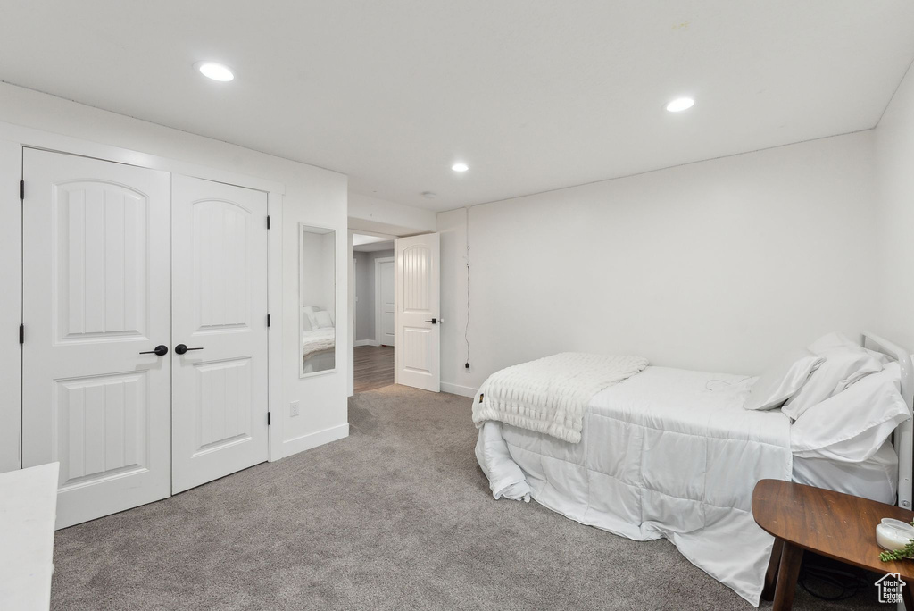 Bedroom with carpet floors, recessed lighting, baseboards, and a closet