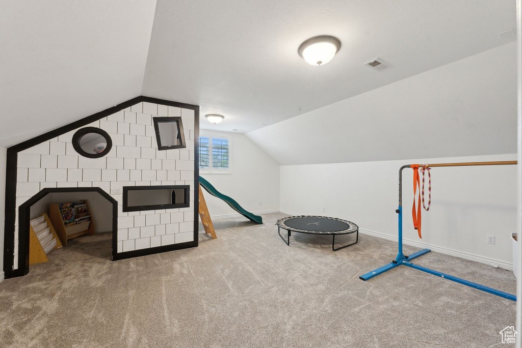 Game room featuring vaulted ceiling, carpet, and baseboards