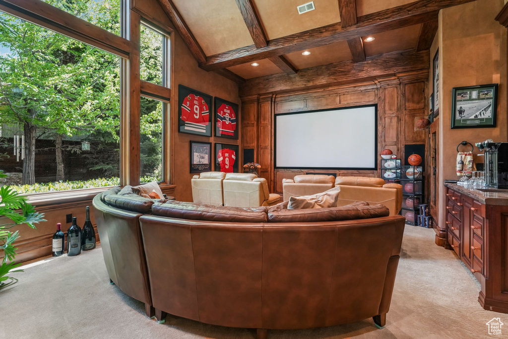 Cinema room with light colored carpet, beam ceiling, and coffered ceiling