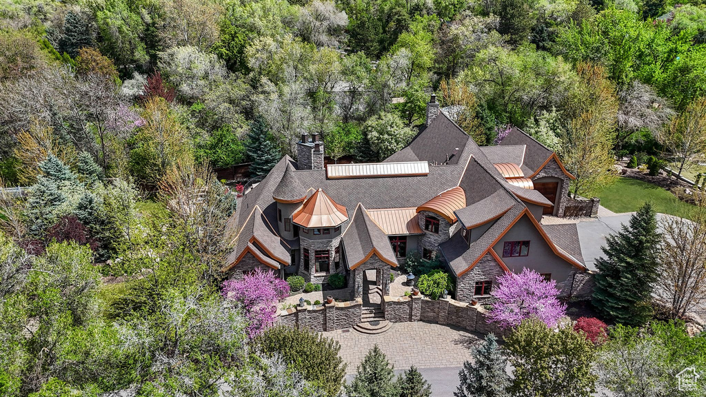 Aerial view of property and surrounding area with a forest