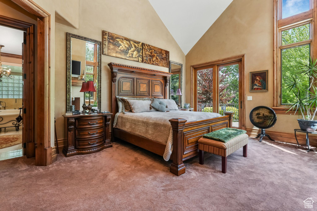 Carpeted bedroom featuring high vaulted ceiling, a chandelier, access to outside, and baseboards