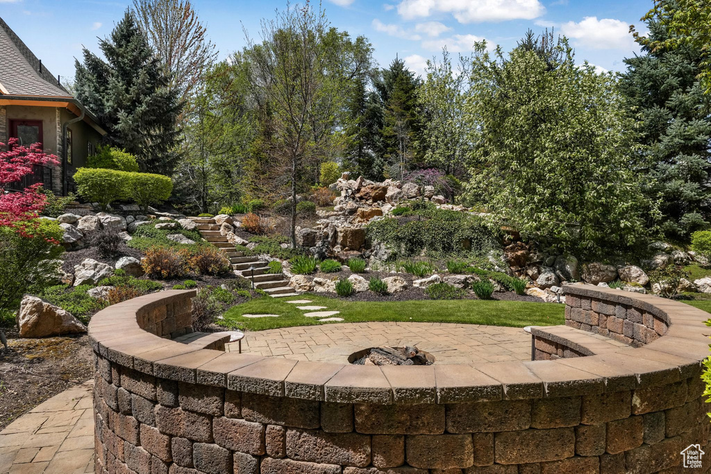 Surrounding community featuring stairs, a fire pit, and a patio area