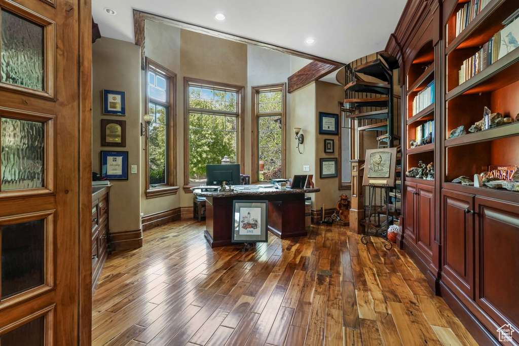 Home office with baseboards, dark wood-type flooring, and recessed lighting