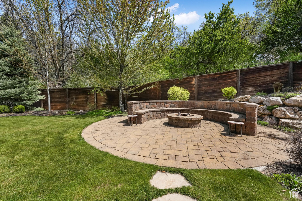 View of patio with an outdoor fire pit