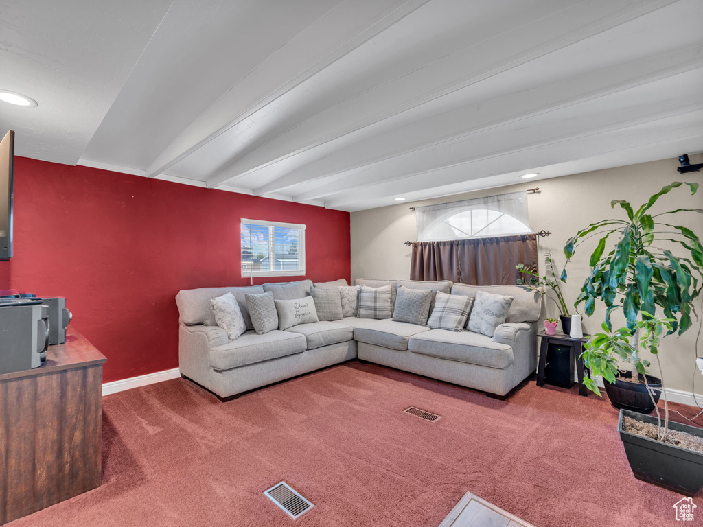 Living room featuring carpet, beam ceiling, baseboards, and recessed lighting
