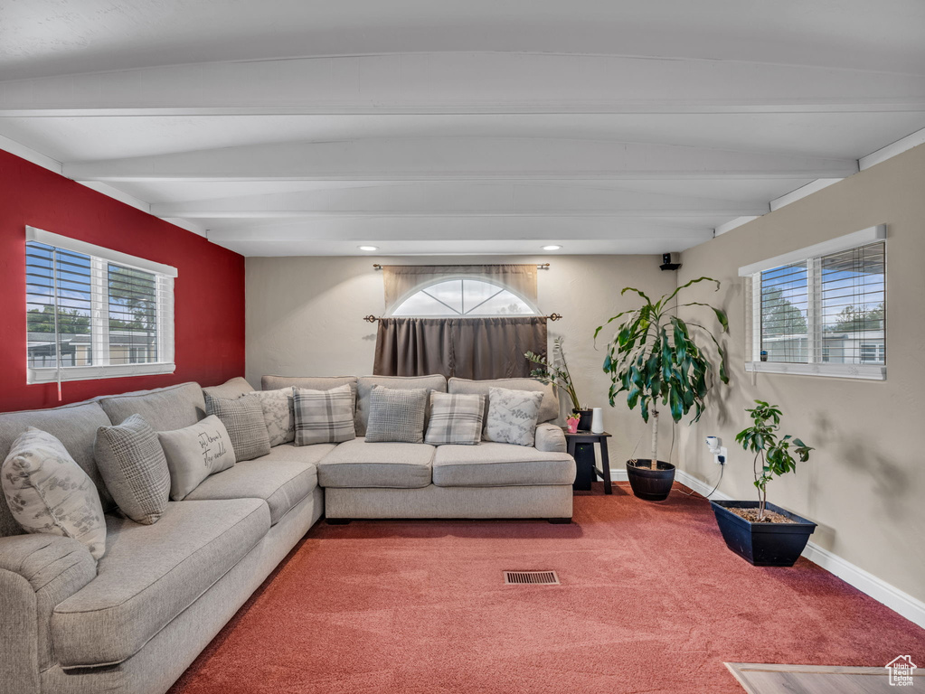 Living room with beam ceiling, plenty of natural light, carpet, baseboards, and recessed lighting