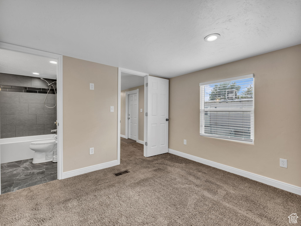 Unfurnished bedroom featuring baseboards, recessed lighting, carpet, and ensuite bathroom