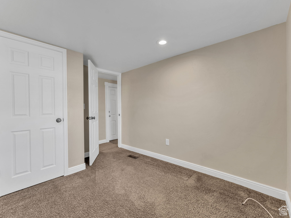Unfurnished bedroom with carpet flooring, baseboards, and recessed lighting