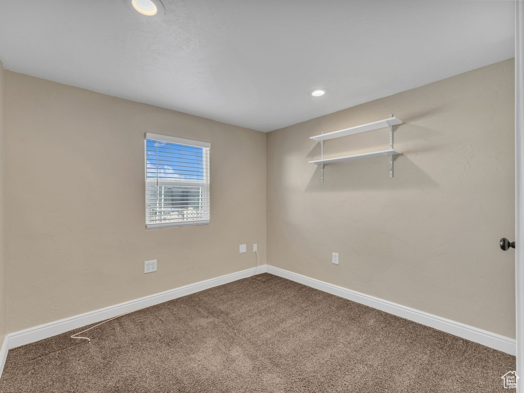 Empty room with carpet flooring, baseboards, and recessed lighting