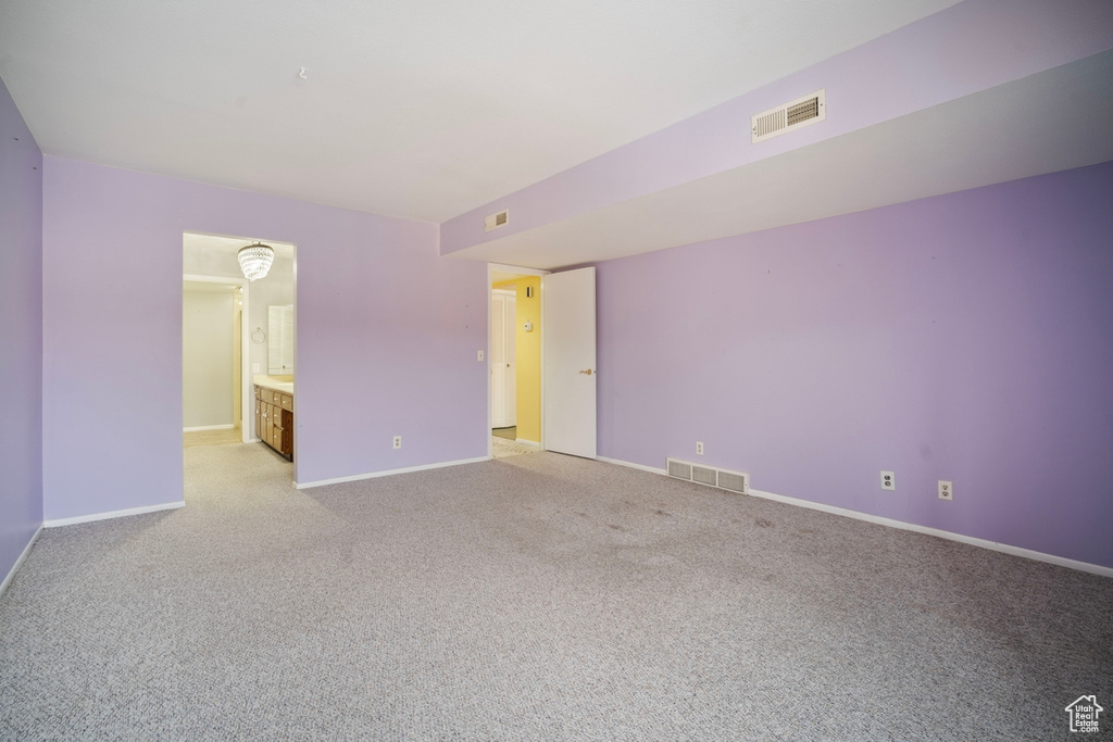 Unfurnished room featuring baseboards and light colored carpet