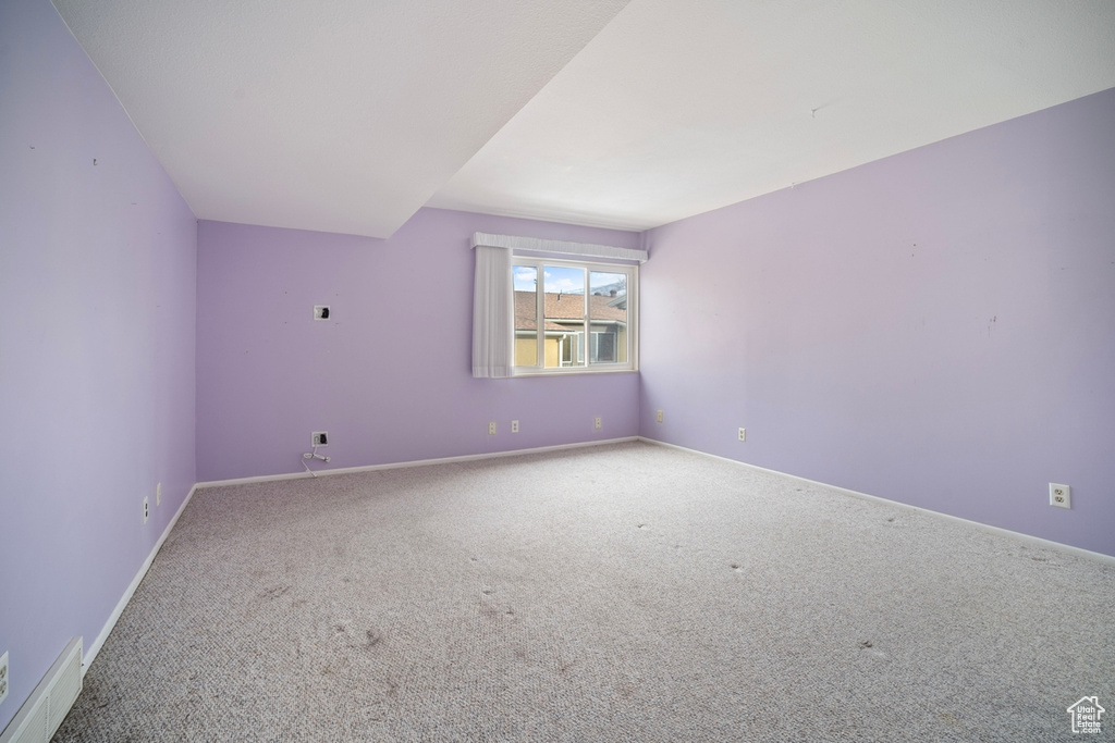Additional living space featuring carpet floors and baseboards