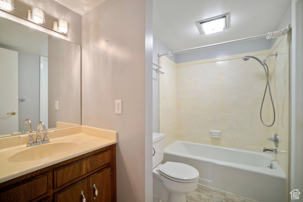 Full bathroom featuring toilet, bathtub / shower combination, and vanity