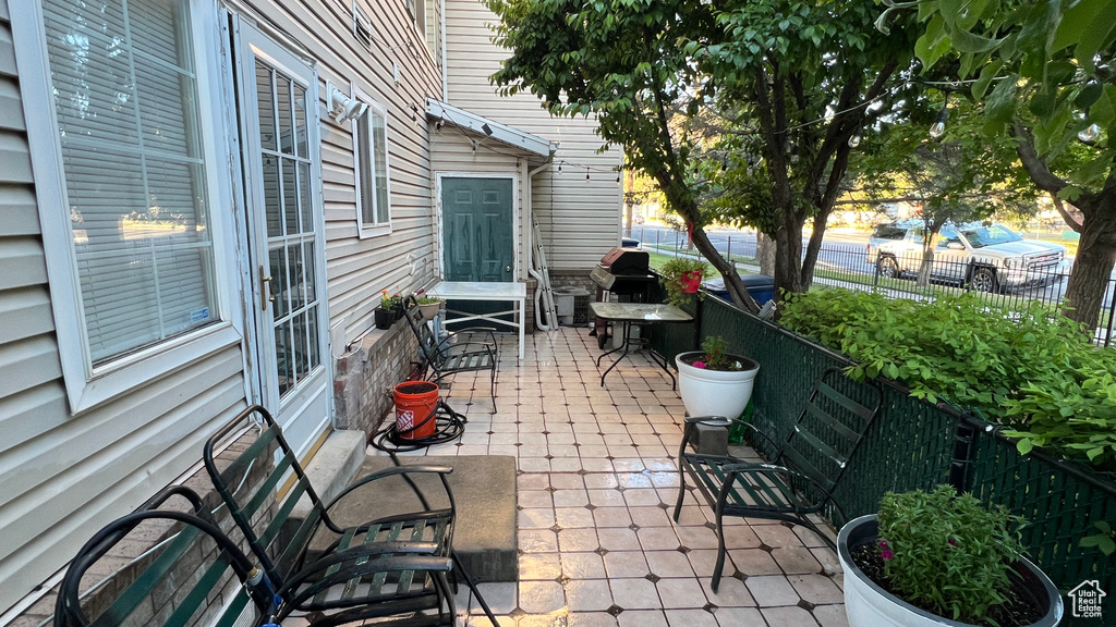 View of patio featuring fence