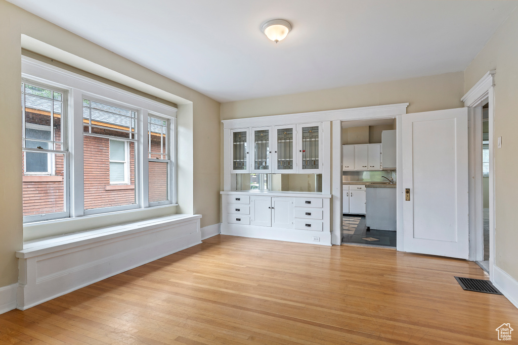 Empty room with light wood-type flooring and baseboards