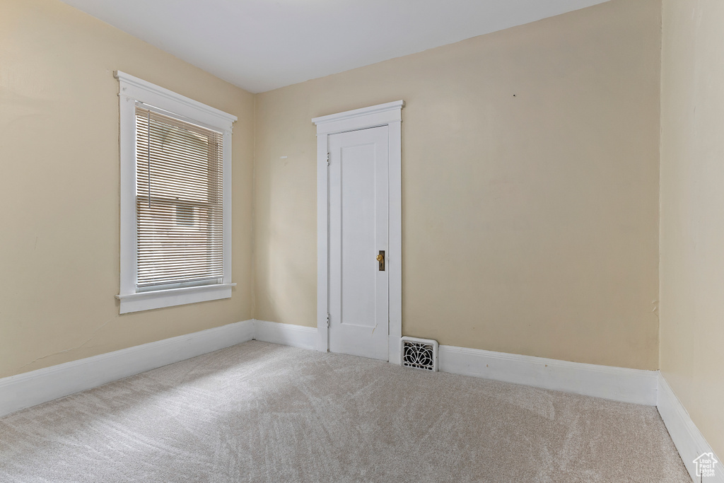 Unfurnished room featuring carpet floors and baseboards