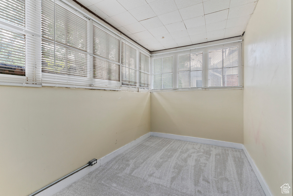 Spare room featuring carpet floors and baseboards