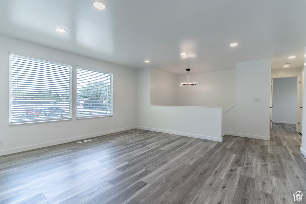 Unfurnished room with light wood-style floors, recessed lighting, and baseboards