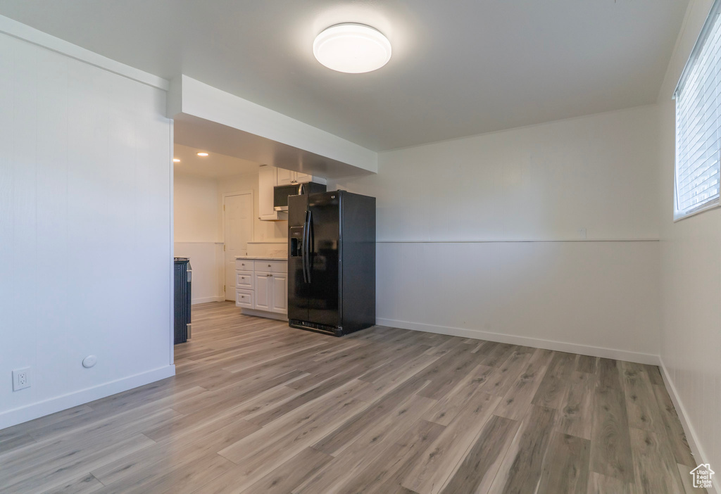 Spare room featuring light wood-type flooring and baseboards