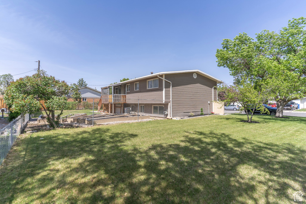 Rear view of property with a vegetable garden