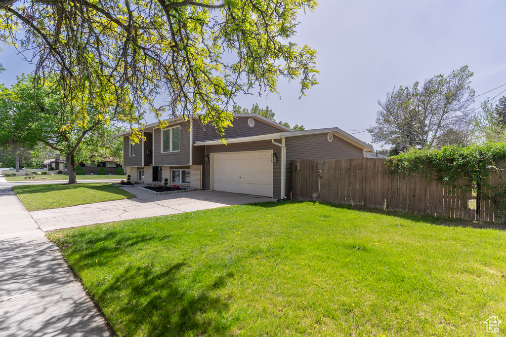 View of side of home with driveway and a garage